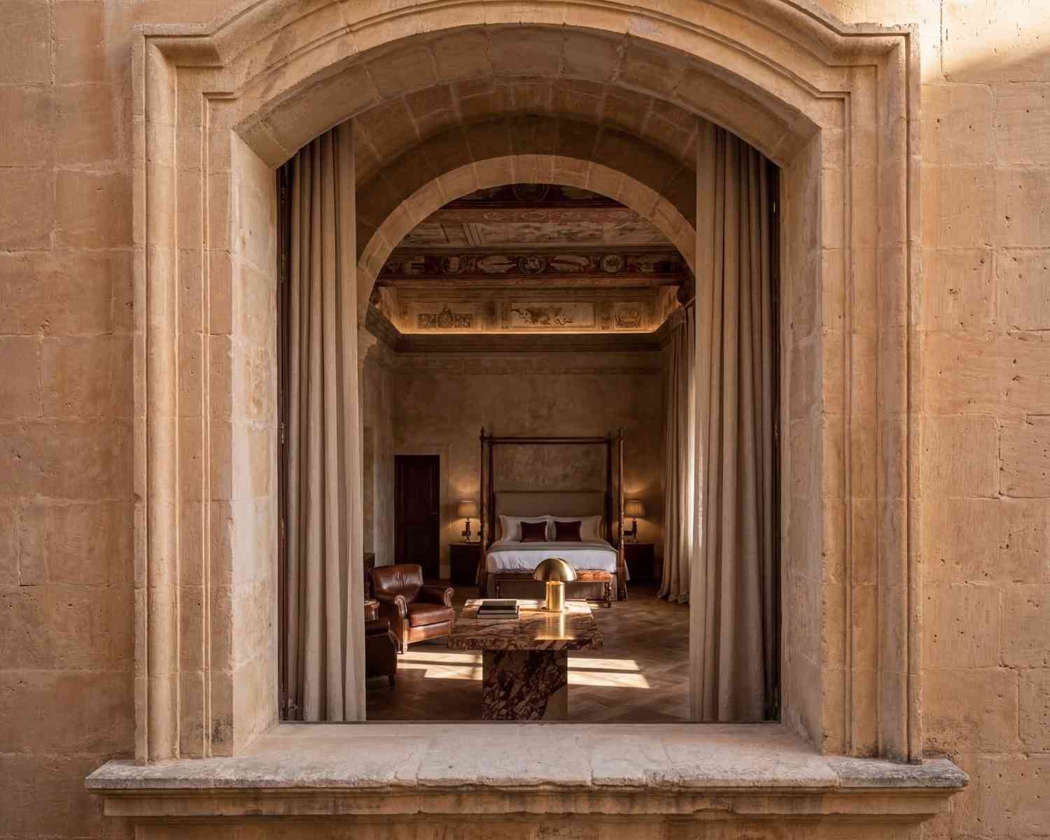 Limestone arch framing the suite — Four Seasons Auberge