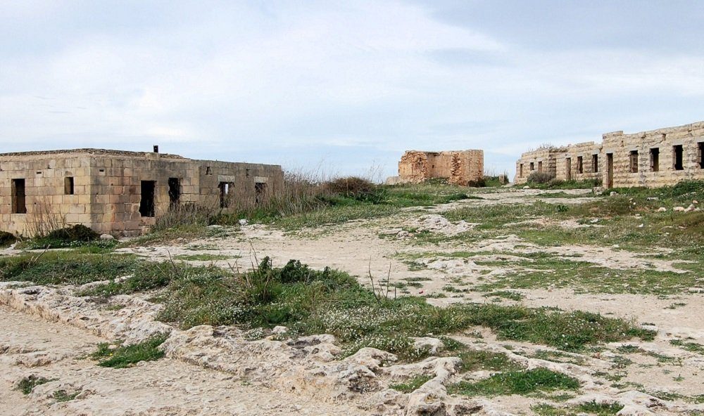 Fort Campbell as it stands — weathered limestone walls, overgrown ground, the cliff edge beyond